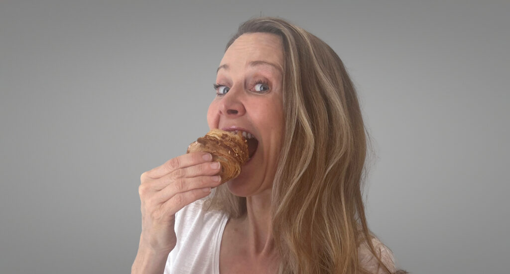 Business owner enjoying a pastry during a relaxed brand photoshoot showing how everyday moments can become meaningful props
