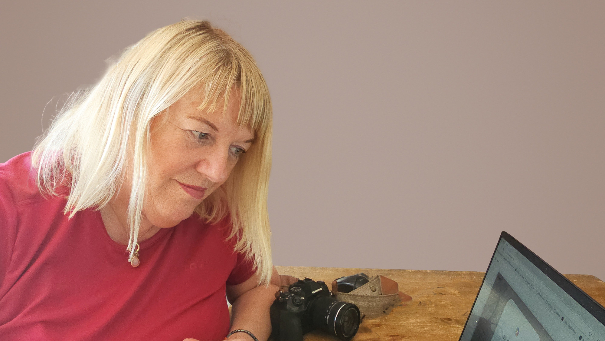business owner reviewing brand photography options on laptop in calm workspace